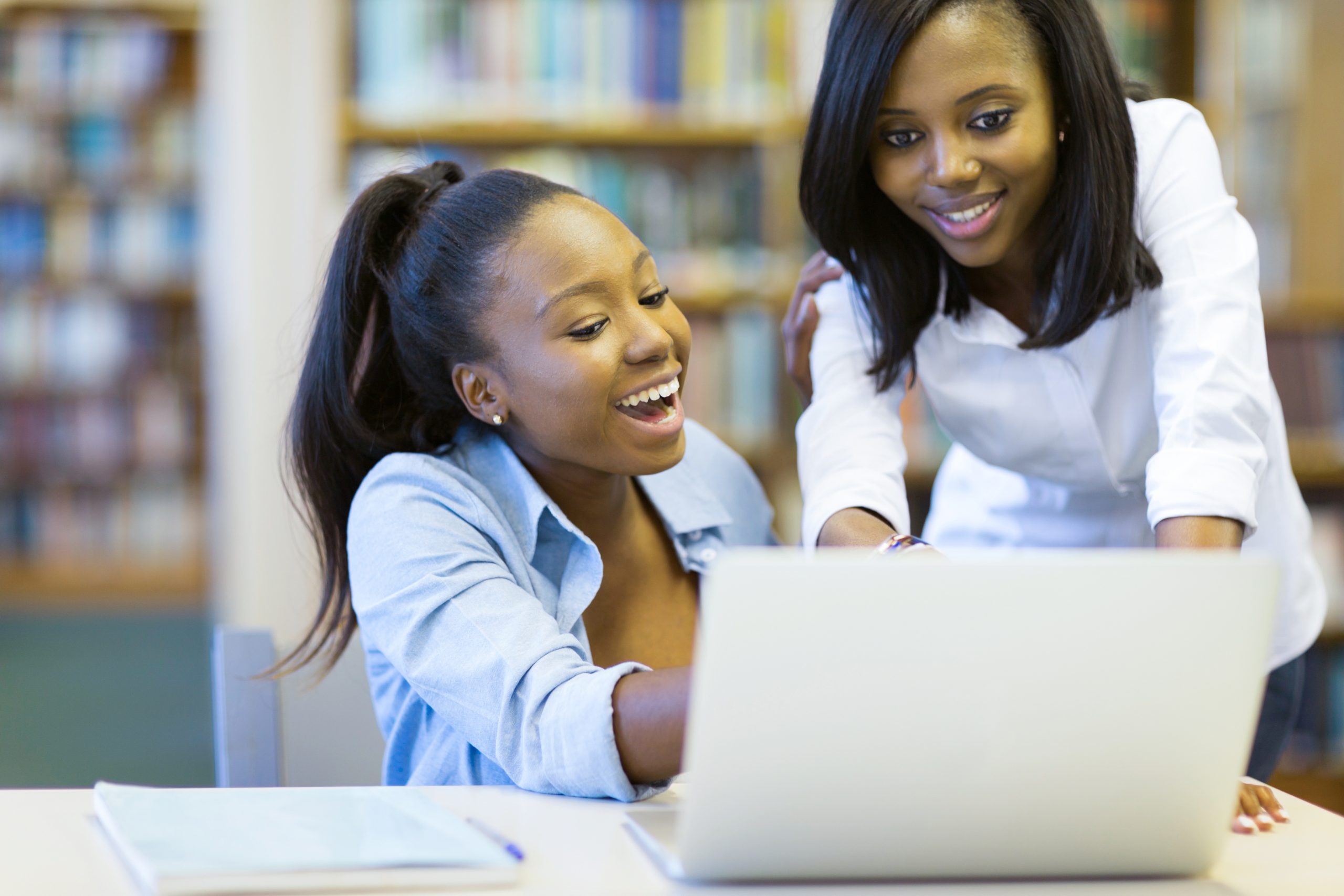 modern african american college students using laptop